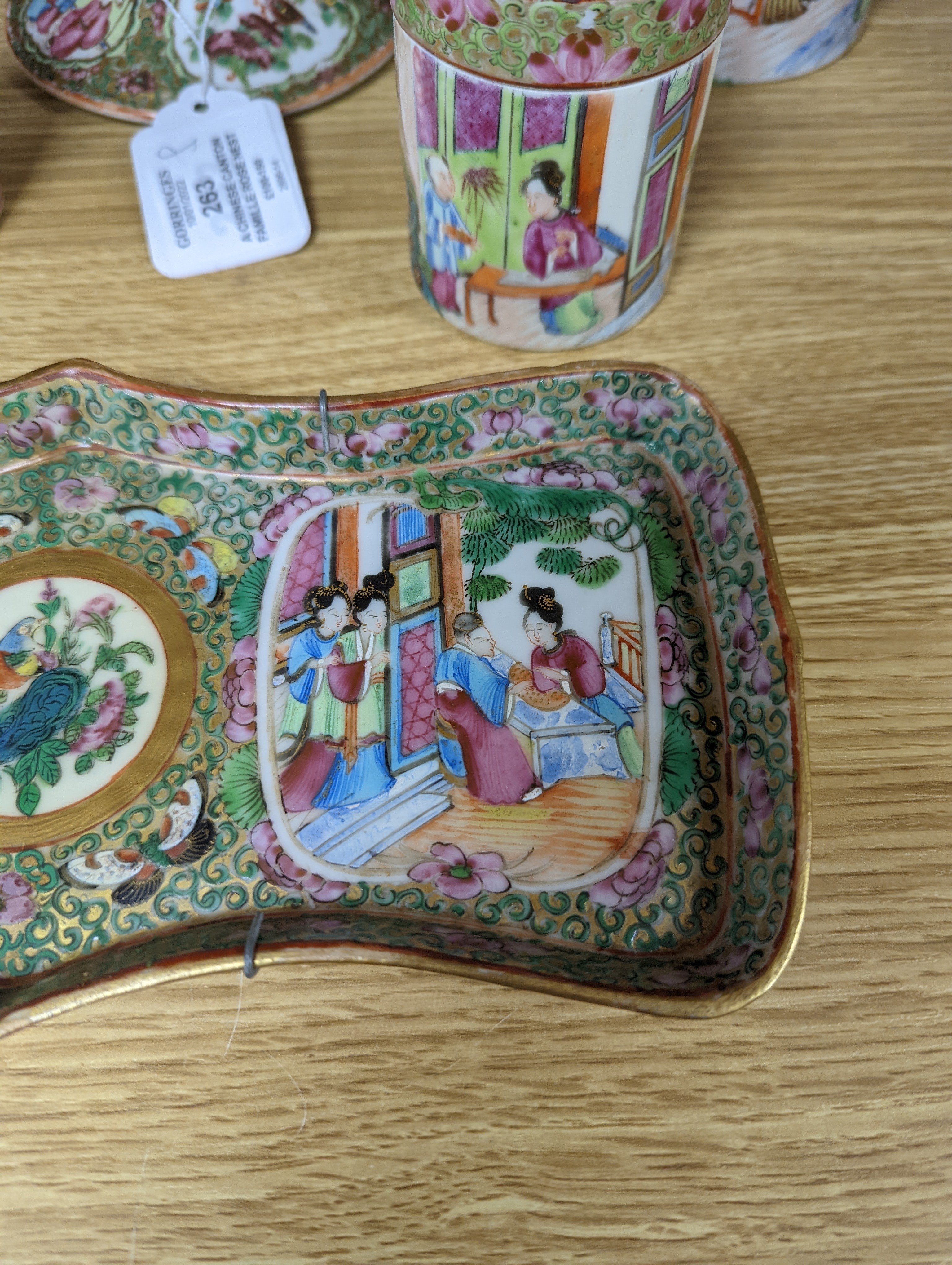 A Chinese Canton famille rose nest of boxes and covers, a similar candlestick and a tray 23cm
